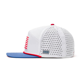 Side view of a white Alter Ego Running perforated hat with red stripe flag patch, blue brim, and red trim detailing.