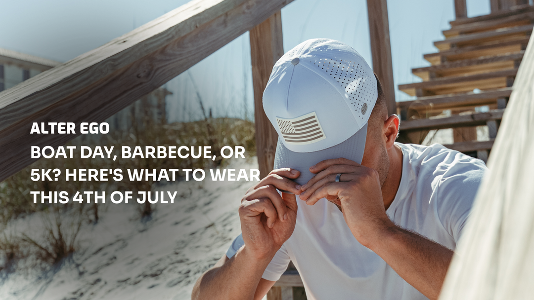 Man wearing a white Alter Ego performance hat and white T-shirt at the beach, featured in a Fourth of July style guide for boat days, barbecues, and 5K races."
