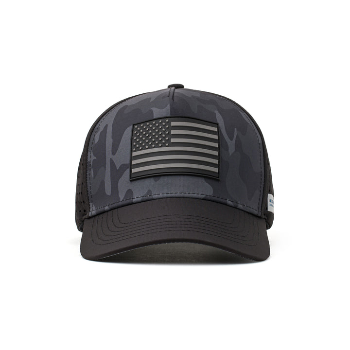 Front view of a black performance cap with a bold black American flag patch and a structured design, perfect for outdoor enthusiasts and athletes.
