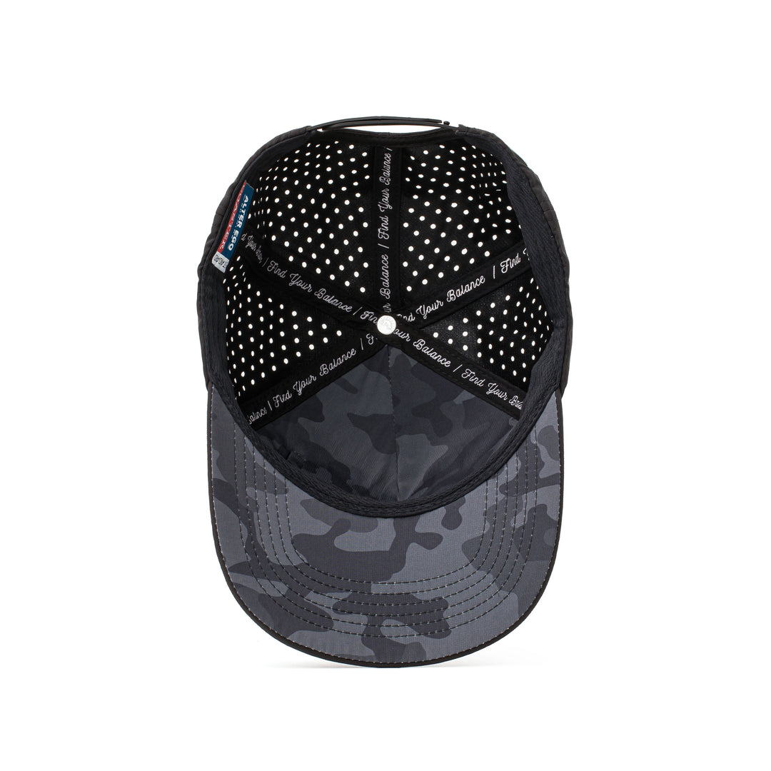 Interior and back view of a black hat with a dark camo mesh panel, adjustable strap, and perforated details for optimal airflow and comfort.