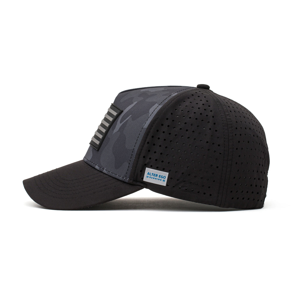 Side view of a black hat featuring a dark camo pattern, black flag logo patch, and lightweight construction, ideal for active and casual wear.