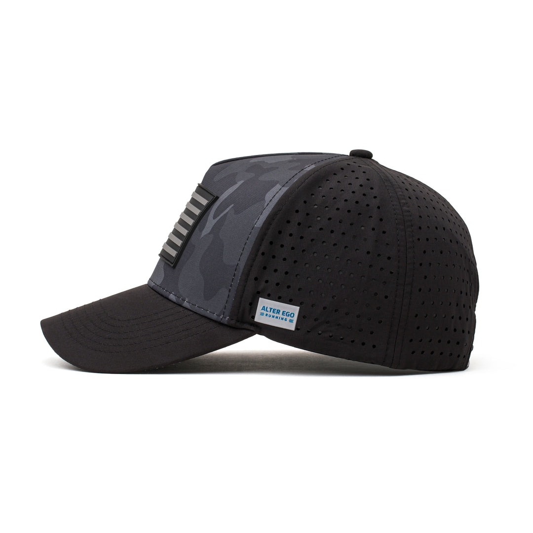 Side view of a black hat featuring a dark camo pattern, black flag logo patch, and lightweight construction, ideal for active and casual wear.