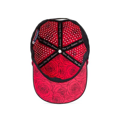 Interior and back view of a black hat featuring red patterned mesh panels, an adjustable strap, and a sweat-wicking lining for active use.