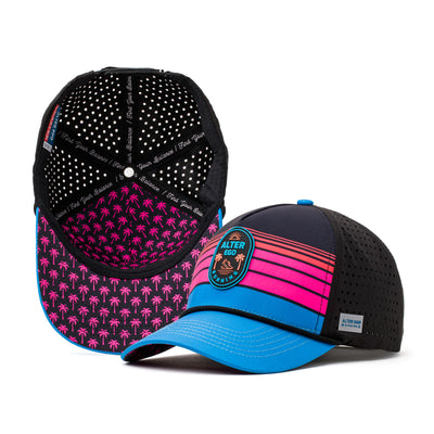 Black performance hat with a pink and black honeycomb-patterned mesh back, neon pink and blue striped front panel, and a vibrant blue brim, designed for active lifestyles.