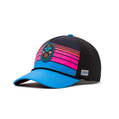 Side-angle view of a black performance hat with neon pink and blue gradient stripes on the front panel, circular tropical logo emblem, perforated breathable sides, and a vibrant blue curved brim designed for athletic and outdoor wear.