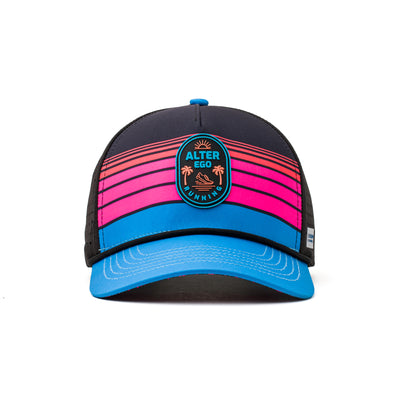 Front view of a performance hat featuring a neon pink and blue striped panel, circular logo emblem, and a bright blue curved brim for a bold, athletic look.