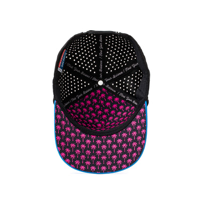 Angled top-down view of a performance hat with neon pink and blue stripes on the front panel and a contrasting honeycomb mesh pattern on the back.