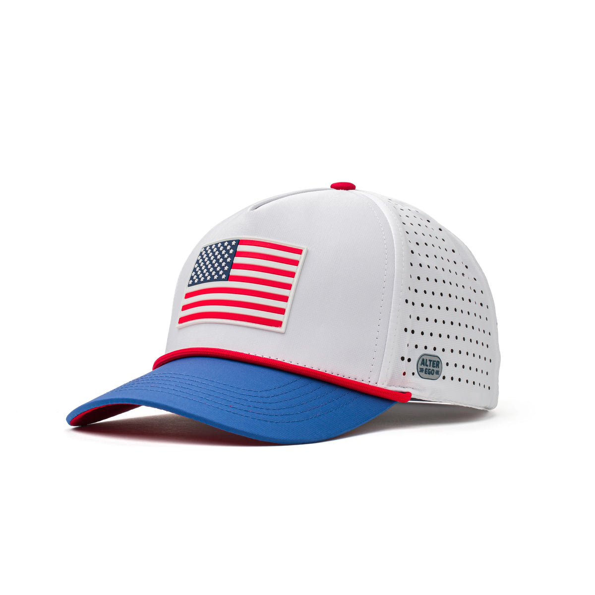 Three-quarter view of the Coaster Splash White USA Flag performance hat featuring a raised American flag patch, blue curved brim, red accent trim, and perforated side panels.