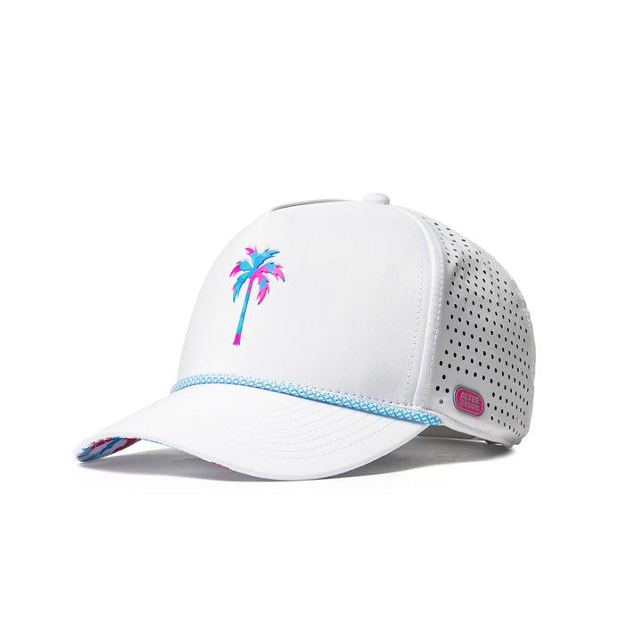 Alter Ego Coaster Splash Key West Camo Palm white running hat with pink and blue palm graphic, blue rope detail, pink Alter Ego branding patch, and laser-cut side panels, shown from angled front view.