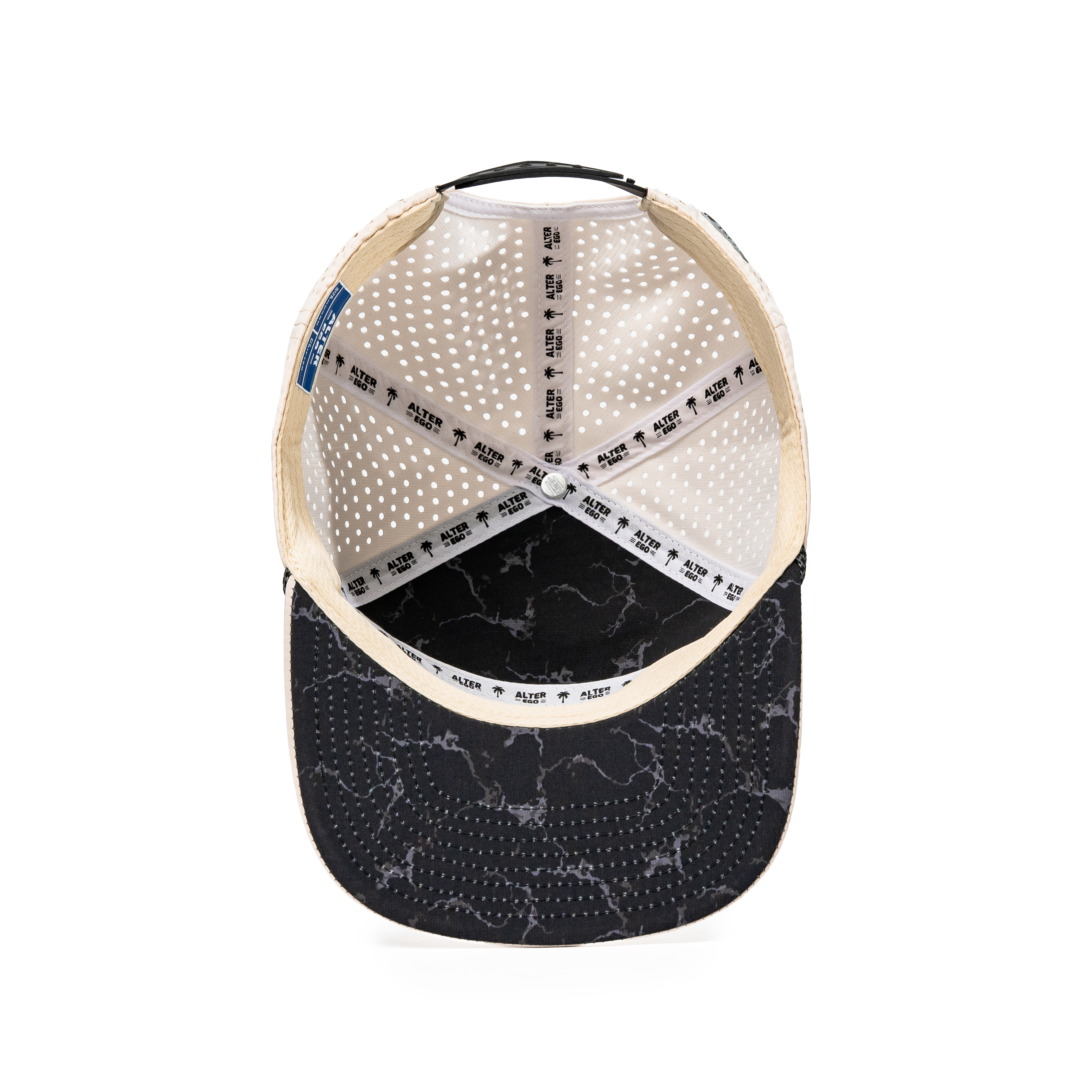 Inside view of the Drifter Splash Ivory Mummy hat showing the ivory interior, Alter Ego branded seam tape, perforated panels, and black marble-patterned flat bill.