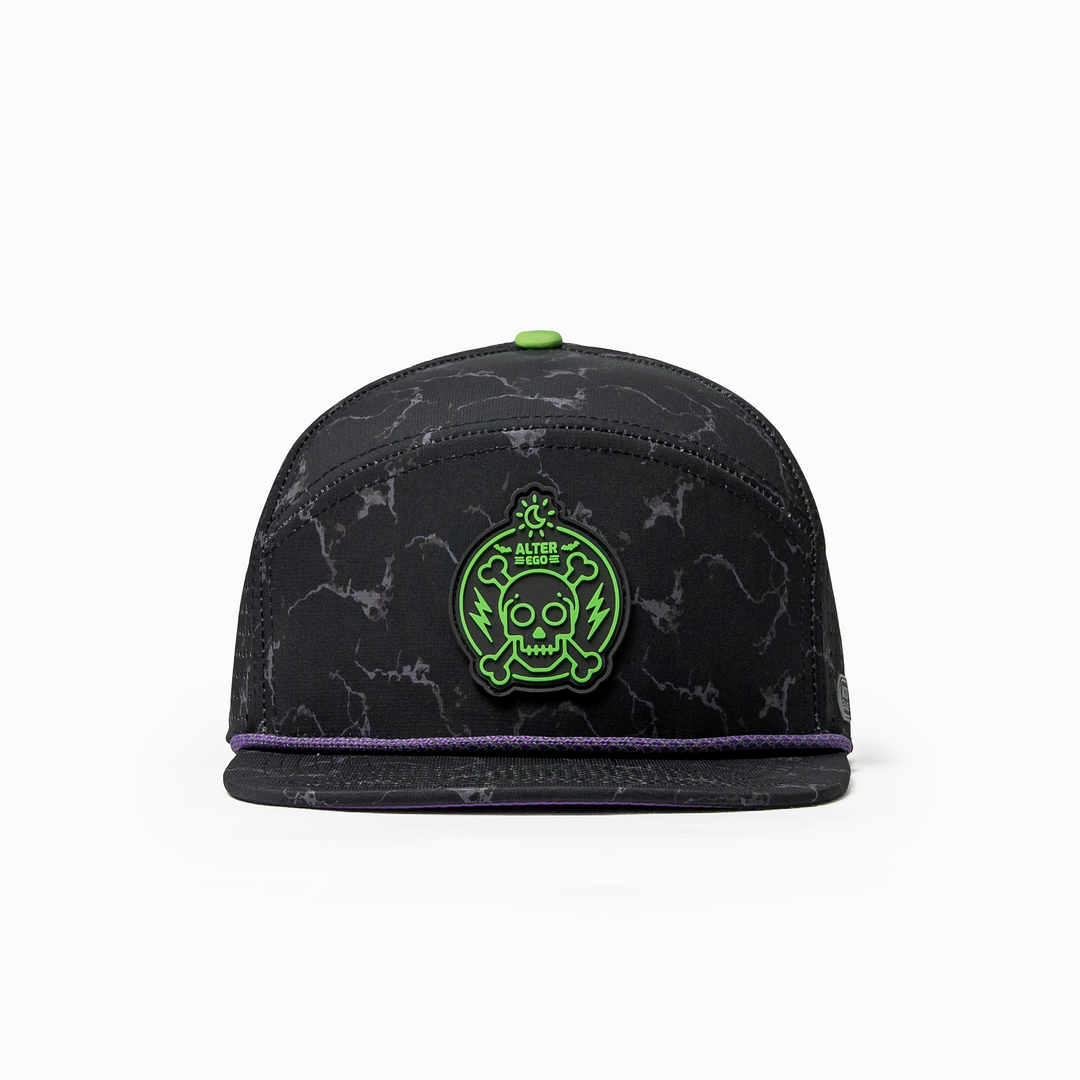 Front view of the Drifter Splash Toxic Storm performance hat featuring a black lightning pattern, flat bill, purple accent rope, and neon green skull graphic.