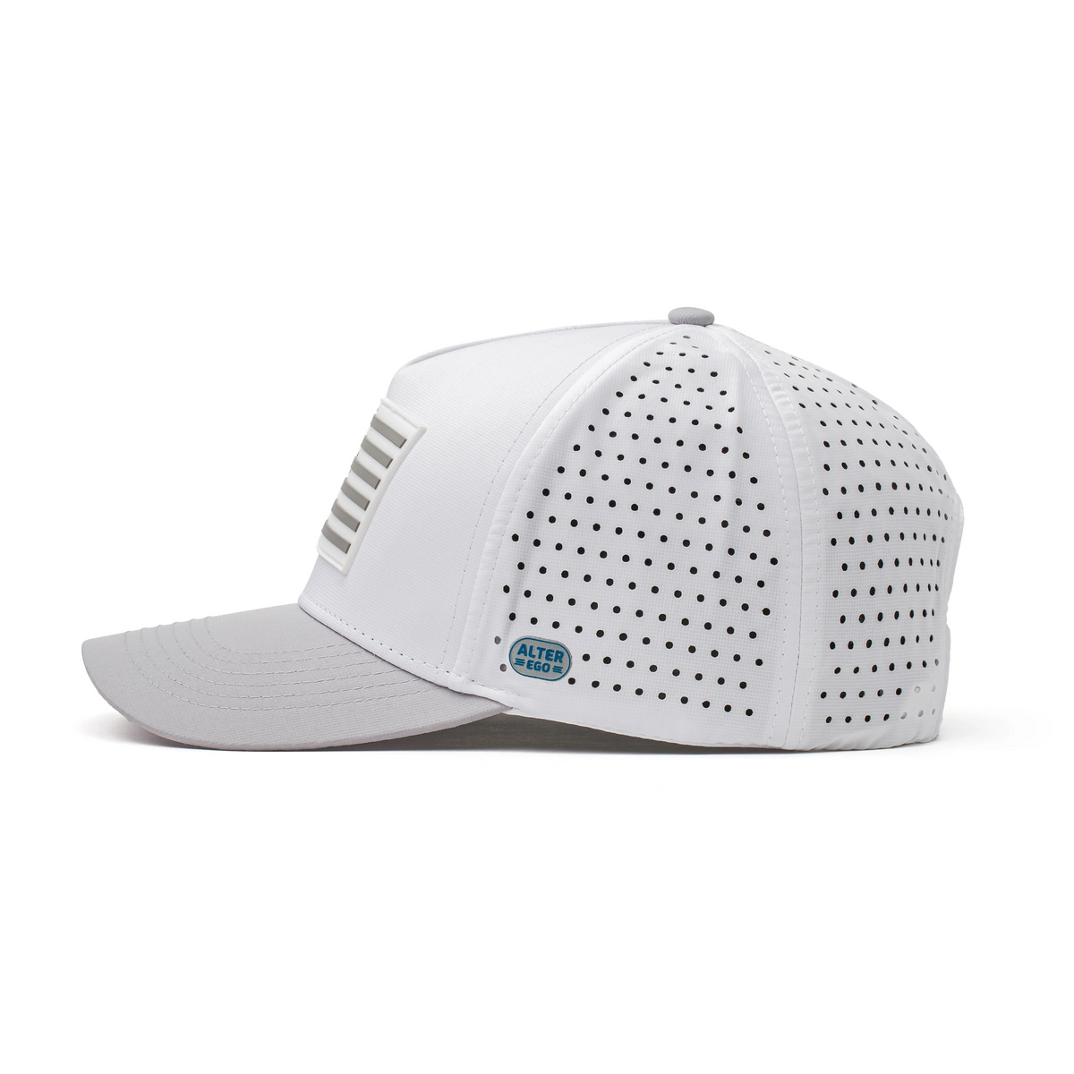 Side view of the Coaster Splash Glacier White Silver Flag performance hat with a raised silver American flag patch, curved brim, laser-cut perforated side panels, and tonal side badge.